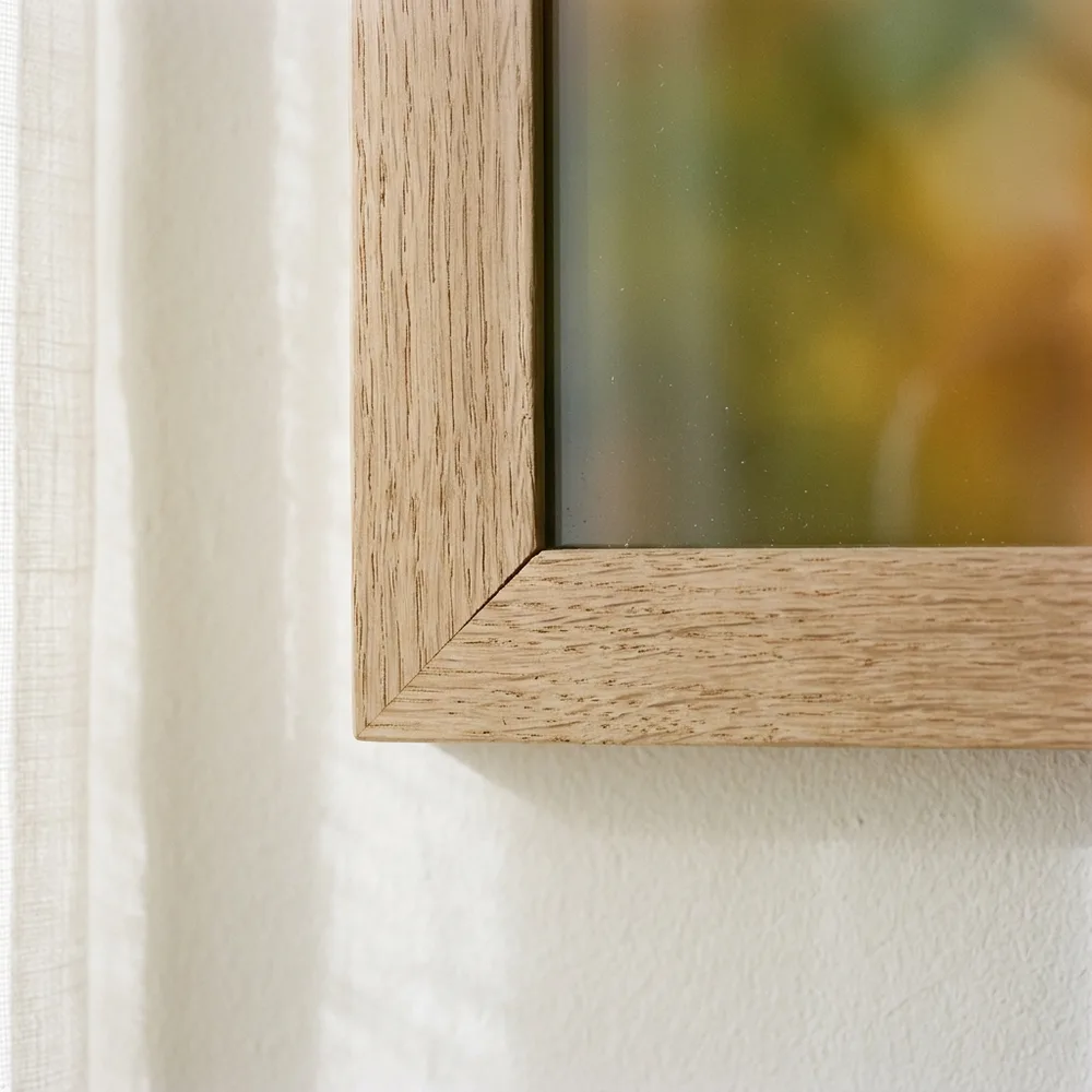 A wood frame mitre, the sheet running clean to the timber